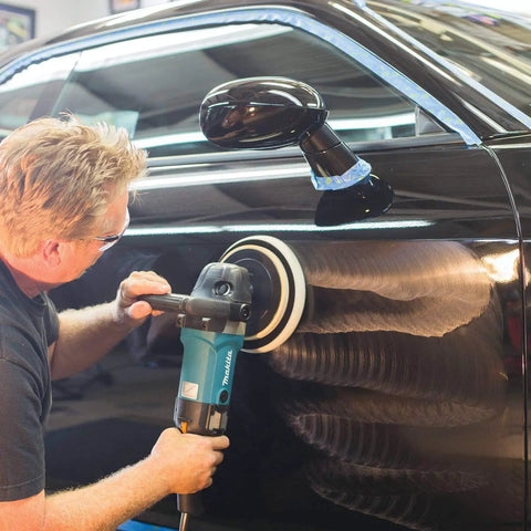 Man using a 7-Inch Polisher With Pro Grade Variable Speed Dial, Constant Speed Under Load, on a black car for paint correction.