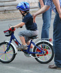 Child on bike with 180 Pcs Spoke Covers Set For Bikes And Dirt Bikes, 10 Color Variety on wheels, adult guiding.
