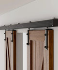Double Barn Door Hardware, Twelve Foot Heavy Duty Aluminum Box Rail, Smooth Glide Sliding Track System installed above wooden doors.