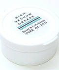 Front view of white plastic jar lid with High Vacuum Grease label, 1 oz (28 g), teal and black stripes.