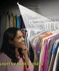 Ultra Bright Button LED Lights With Adhesive Backing Pack illuminating a dark closet, showing clothes on hangers.