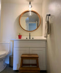 Retro Sconce With Slope Pole Wall Mount And 7.9 Inch Glass Globe Shade in bathroom setting over a vanity mirror.