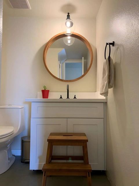 Retro Sconce With Slope Pole Wall Mount And 7.9 Inch Glass Globe Shade in bathroom setting over a vanity mirror.