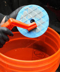Cleaning a 5 Pc 5 Inch Orbital Polisher Pads Set With 1 Microfiber Buffing Pad For Car Detailing in orange bucket