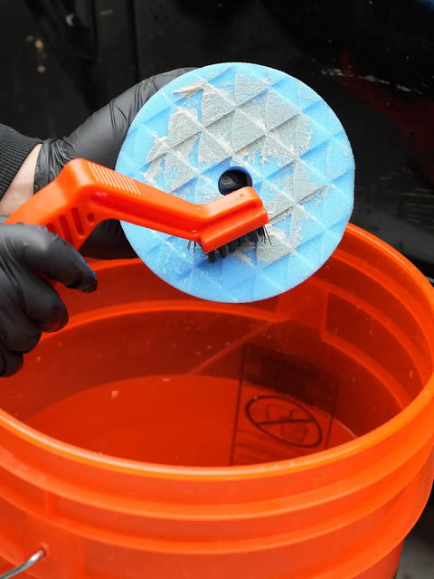 Cleaning a 5 Pc 5 Inch Orbital Polisher Pads Set With 1 Microfiber Buffing Pad For Car Detailing in orange bucket