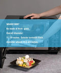 Hand placing food inside microwave with open door, glass turntable labeled WB49X10097 on display