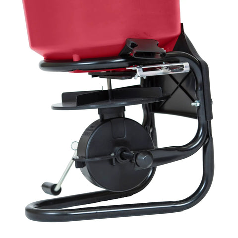 Close-up of Pro Grade Chest Mount Hand Crank Spreader with Even Spread Technology, showing mechanism and part of 40 lb hopper.