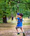 Child using Backyard Zip Line Slider For Obstacle Course With 440 Pound Capacity Smooth Glide Durable Outdoor Toy in park