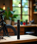 Sturdy Steel 25.4mm Bike Seat Post For Kids Bicycles Black Finish Fits 25.4mm Seat Tubes in workshop setting.