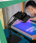 Man using 50W LED UV Screen Printing Exposure Unit With Retractable Adjustable Stand for emulsion curing on blue screen
