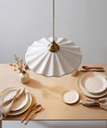 Premium White Scalloped Ceramic Pendant Light Adding Sweet Vintage Charm To Kitchen Islands Built Tough With Heat Resistant Glaze Handling Humidity Like A Champ Snag This Clean Modern Look Today hanging above a wooden table set with plates and utensils.