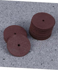 Stack of grinding wheels from 36 Piece Heavy Duty Cutting Discs And Grinding Wheels Set For Metal, Wood, And Ceramics on grey surface.