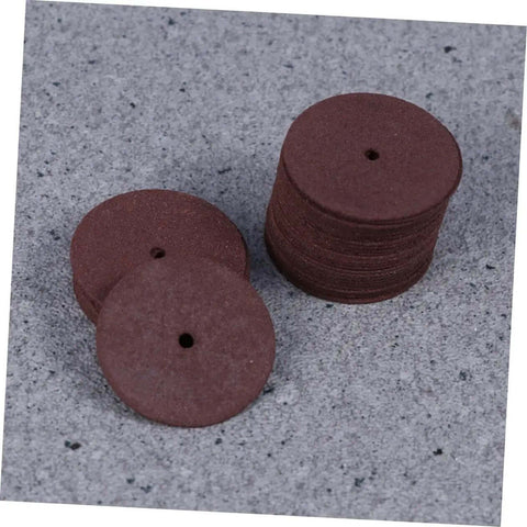 Stack of grinding wheels from 36 Piece Heavy Duty Cutting Discs And Grinding Wheels Set For Metal, Wood, And Ceramics on grey surface.