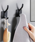 Badass No Drill Wall Mounted Coat Rack Hook Rail Organizer For Entryway Living Room Bedroom Heavy Duty Metal Surface Hanging Rack Strong Adhesive Silver Finish holds a towel and brush.