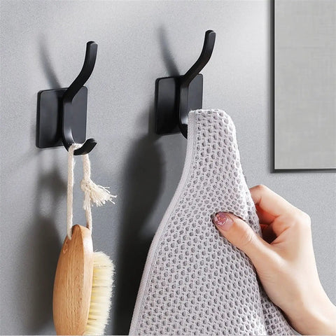 Badass No Drill Wall Mounted Coat Rack Hook Rail Organizer For Entryway Living Room Bedroom Heavy Duty Metal Surface Hanging Rack Strong Adhesive Silver Finish holds a towel and brush.