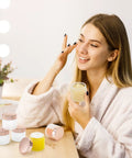 Score 16 Fresh 2 Oz Frosted Glass Sample Jars With Sleek Rose Gold Screw Caps and Tight Inner Liners with a woman applying lotion.