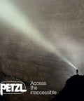Person using Rechargeable Headlamp With Reactive Lighting Technology, 900 Lumens, on a dark cliff face at night.