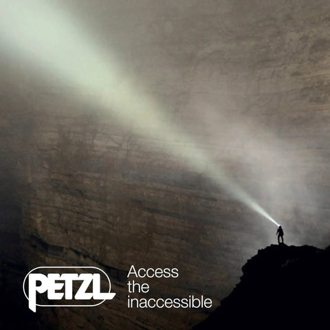 Person using Rechargeable Headlamp With Reactive Lighting Technology, 900 Lumens, on a dark cliff face at night.