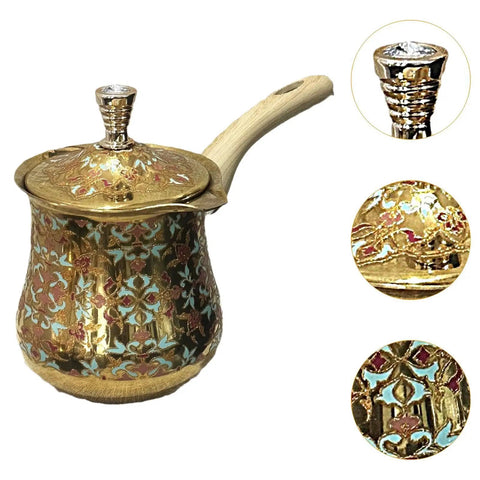 Ornate brass milk warmer and coffee pot with long handle, featuring intricate designs, shown from a side angle.