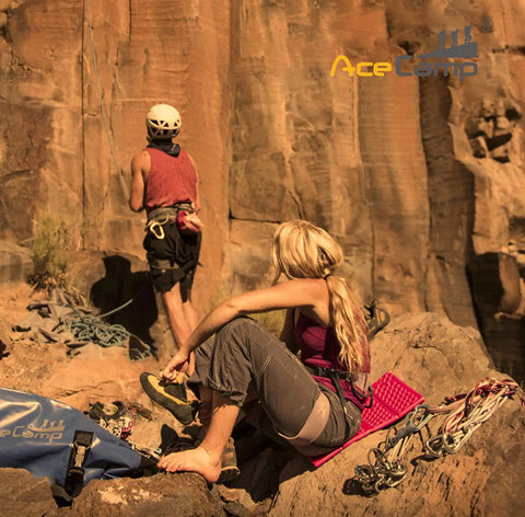 Two climbers on rocky terrain with gear, one sitting on Ultralight Camping Sit Pad For Backpacking And Hiking, Pink, by AceCamp