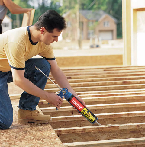 Man using 3X Stronger Do-It-All Polyurethane Construction Adhesive 10 Oz Cartridge 12 Pack For Wood, Concrete, Stone, Metal And More
