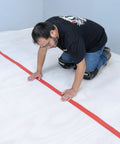 Installation of No Nonsense Foam Underlayment Roll Quiet Room Padding for Laminate and Engineered Wood Flooring, showing smooth rollout.