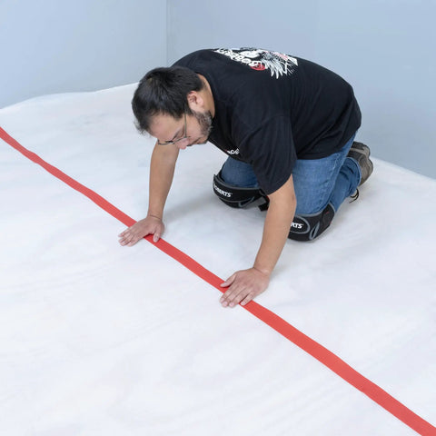 Installation of No Nonsense Foam Underlayment Roll Quiet Room Padding for Laminate and Engineered Wood Flooring, showing smooth rollout.