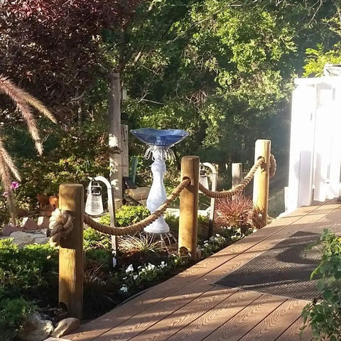 Garden decor with natural posts and 100 Percent Natural Hemp Rope Thick 1 Inch By 100 Ft for landscaping and pathway design.