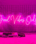 Pink Neon Sign With Dimmable LED Lights For Bedroom And Bar Decor Huge 56.57 Inch Wall Art That Sets Cozy Vibes For Home Parties Clubs And Nightlife Ambient Glow For Chill Vibes displayed on a grid wall, reading 'Good Vibes Only'