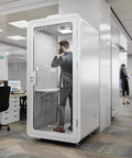 Portable One To Two Person Soundproof Office Pod With Thick Acoustic Panels and Whisper Quiet Ventilation in modern office setting.