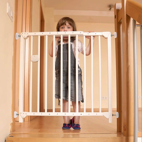 Child behind a safety gate with 4 Pack Baby Gate Wall Protector Cups For Child Safety And Pet Gates Frosted Matte Non Slip Guards