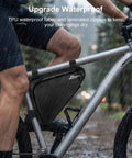 Waterproof triangle bag attached to mountain bike, part of the Bike Tire Repair Kit For Flat Tires With Portable Pump 120 PSI.