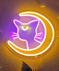 Anime Luna Neon Sign LED Dimmable Moon Cat Night Light For Bedroom Wall Decor Lit Pink Kawaii Neon Light For Girls Room Game Room Dorm Birthday Party Gift Idea on wall with purple cat and yellow moon design.
