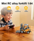 Boy playing with Mini RC Forklift Toy With App Control And Remote, 1:64 alloy crane on table, smiling, indoors.