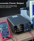High Precision DC Power Supply with Encoder Knob 30V 10A on bench with multimeter and display showing voltage, current readings.