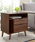 Walnut finish wood side table with angled legs next to a sofa