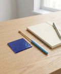 Flame Test Kit For Chemistry Class With Nickel-Chromium Wire, Cobalt Glass Sheet, And Glass Rod Set on a wooden desk