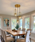 Dining room with Three Light Mid Century Modern Pendant Light Fixture With Gold Finish Glass Globe And Adjustable Cage Hanging Chandelier
