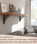 Heavy Duty Shelf Bracket Kit 12 x 12 Inch Set of Two, Cast Iron Finish supporting a wooden shelf above a couch in a living room.