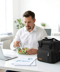 Man eating lunch at office with a Double Deck Insulated Lunch Bag With 15L Capacity, Leakproof Soft Sided Cooler for work.