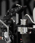 Hand Cranked Espresso Maker Boasting A 58mm Pro Brew Group And Adjustable Pressure Levers, pouring water into portafilter.