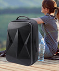 Ultra Compact Satellite Travel Backpack with USB Charging Port, water resistant, custom molded compartments in outdoor setting.