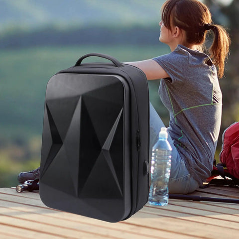 Ultra Compact Satellite Travel Backpack with USB Charging Port, water resistant, custom molded compartments in outdoor setting.