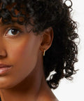 14K Gold Hoop Earrings For Women, Minimalist V-Shaped Open Hoops, Hypoallergenic And Lightweight 17mm Design on model.