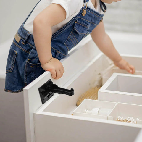 No Drill Childproof Cabinet Locks Pack Of 12 With Strong Adhesion And Easy Install For Drawers Cabinets And Doors Safe Furniture Locks For Kid Proofing shown securing a white drawer to prevent toddler access.