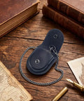 Hella Solid Pocket Watch Case Crafted From Premium Pu Leather Featuring A Snazzy Antique Bronze Chain Secure Snap Closure And Roomy Compartment For Keeping Your Favorites Safe In Classic Black on wooden table.