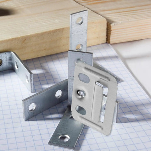 Solid Stainless Steel Wall Panel Connectors For Cabinets And Drywall, close-up of various silver connectors on graph paper.