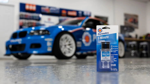 Fast Setting Epoxy Resin Syringe For Quick Bonding, Single Use, All Purpose Formula on table in garage with race car in background