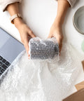 Person wrapping item using Bubble Cushioning Roll, 72 Ft Long, 12 Inch Wide, Three Sixteenth Inch Air Bubbles, Perforated Every 12 Inches