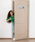Woman smiling next to aluminum restroom sign for women on door; Two Pack Aluminum Restroom Signs For Men And Women Self Adhesive Metal Bathroom Door Wall Signage For Offices Restaurants Public Places 9 By 3 Inches Silvery Finish Easy Mount